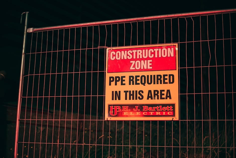 Operatorzy sprawdzający stabilność podnośnika na krakowskiej budowie